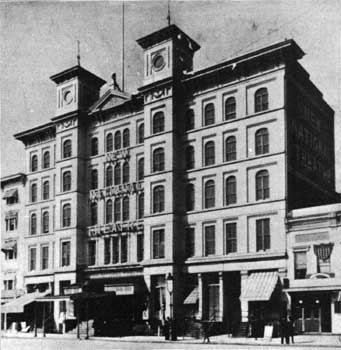 Photograph of National Theatre in 1885 with two towers on the facade of the five story building.