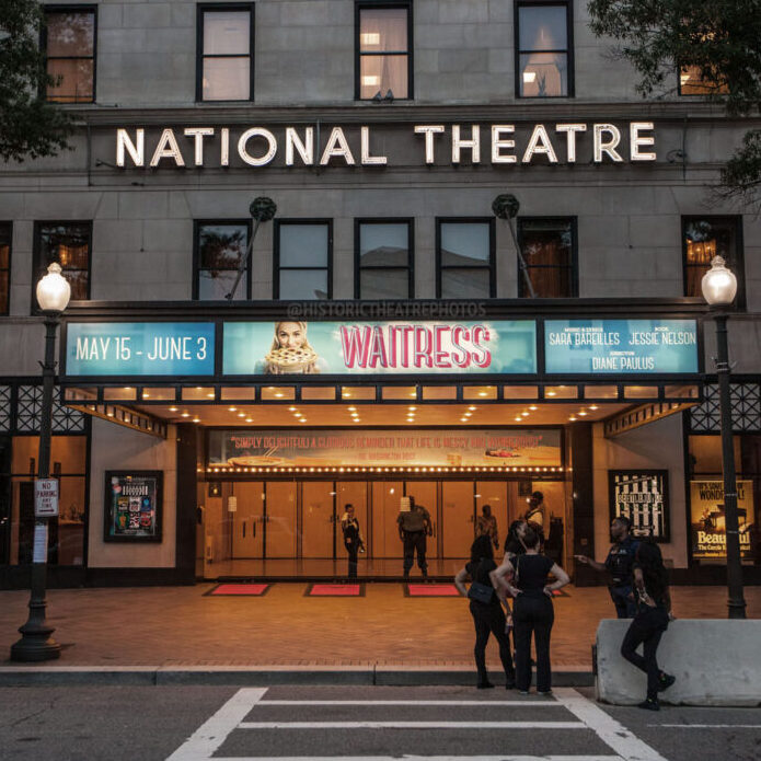 National Theatre marquee at night advertising the show Waitress.