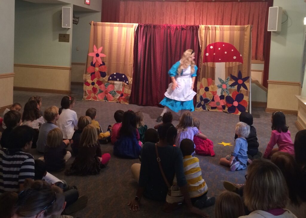 Actress performs Alice in Wonderland to children in the Helen Hayes lounge