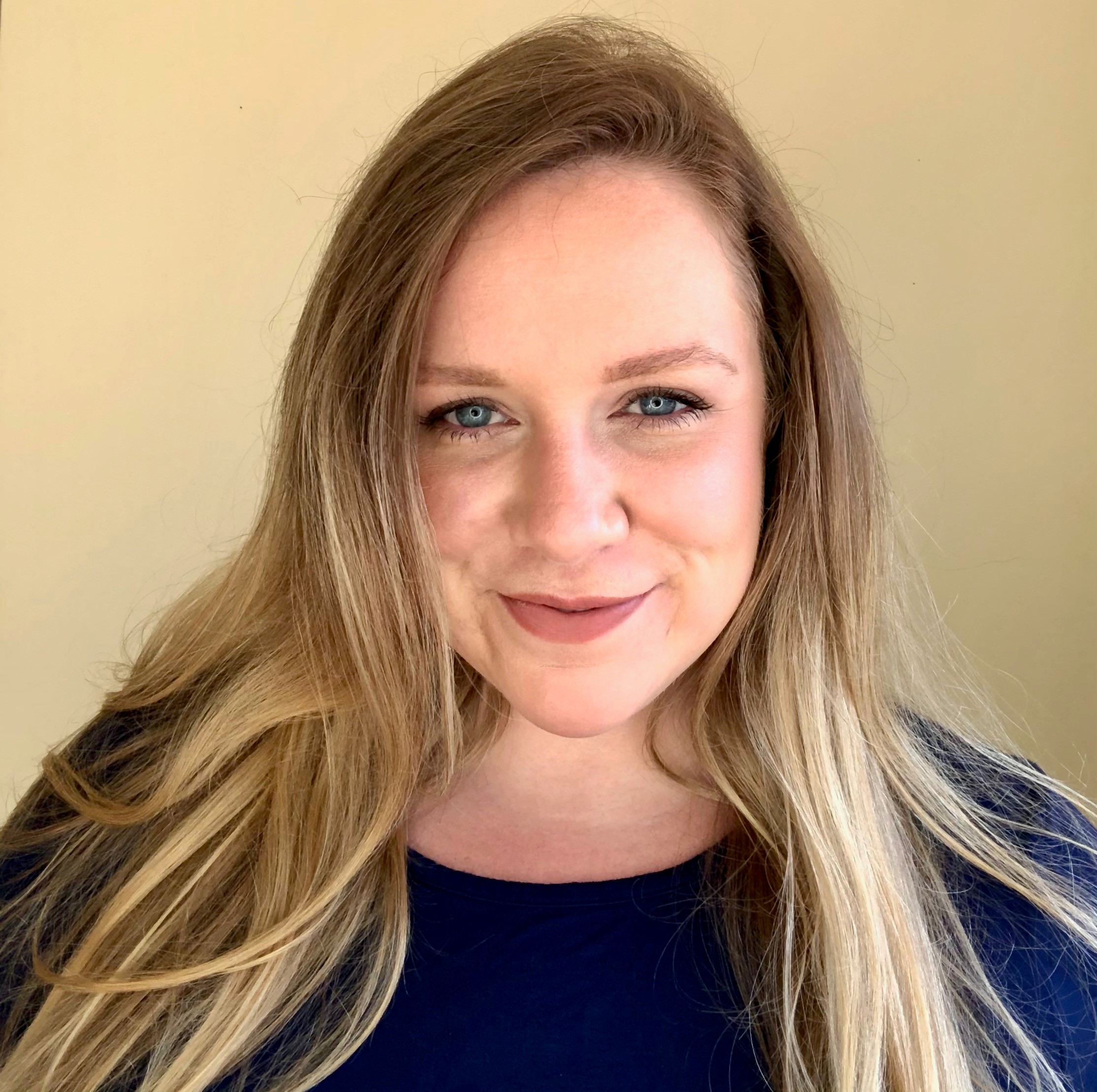 Headshot of a white woman with long blonde hair
