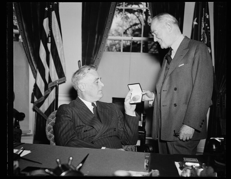 A black and white photograph of President Franklin Delano Roosevelt presenting George M. Cohan with an award.